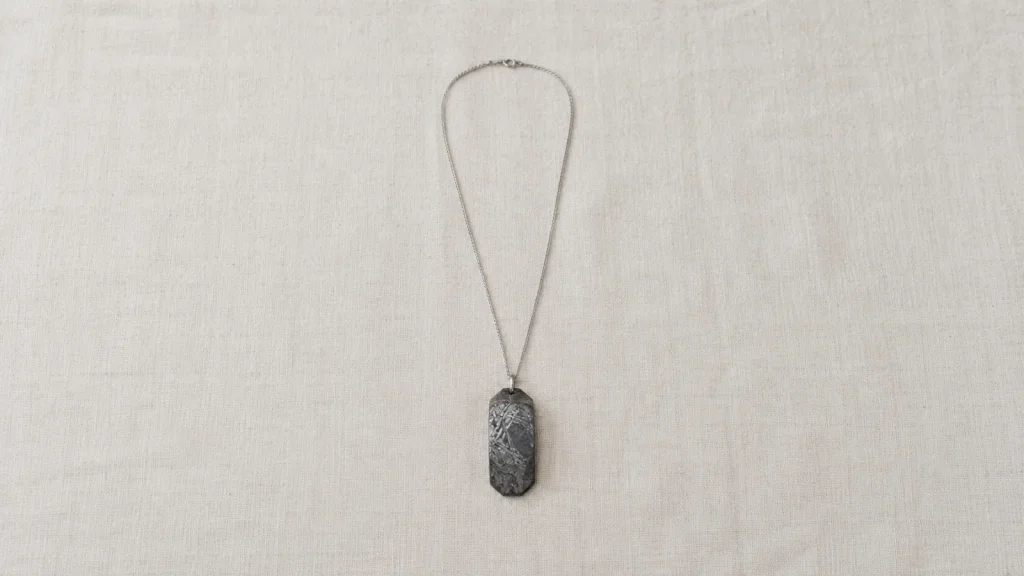 Aletai meteorite pendant and chain on linen