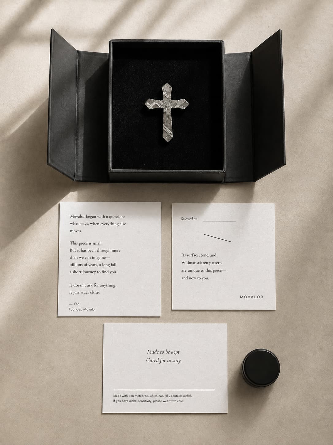 Movalor magnetic gift box open, showing meteorite pendant with meaning card and care kit
